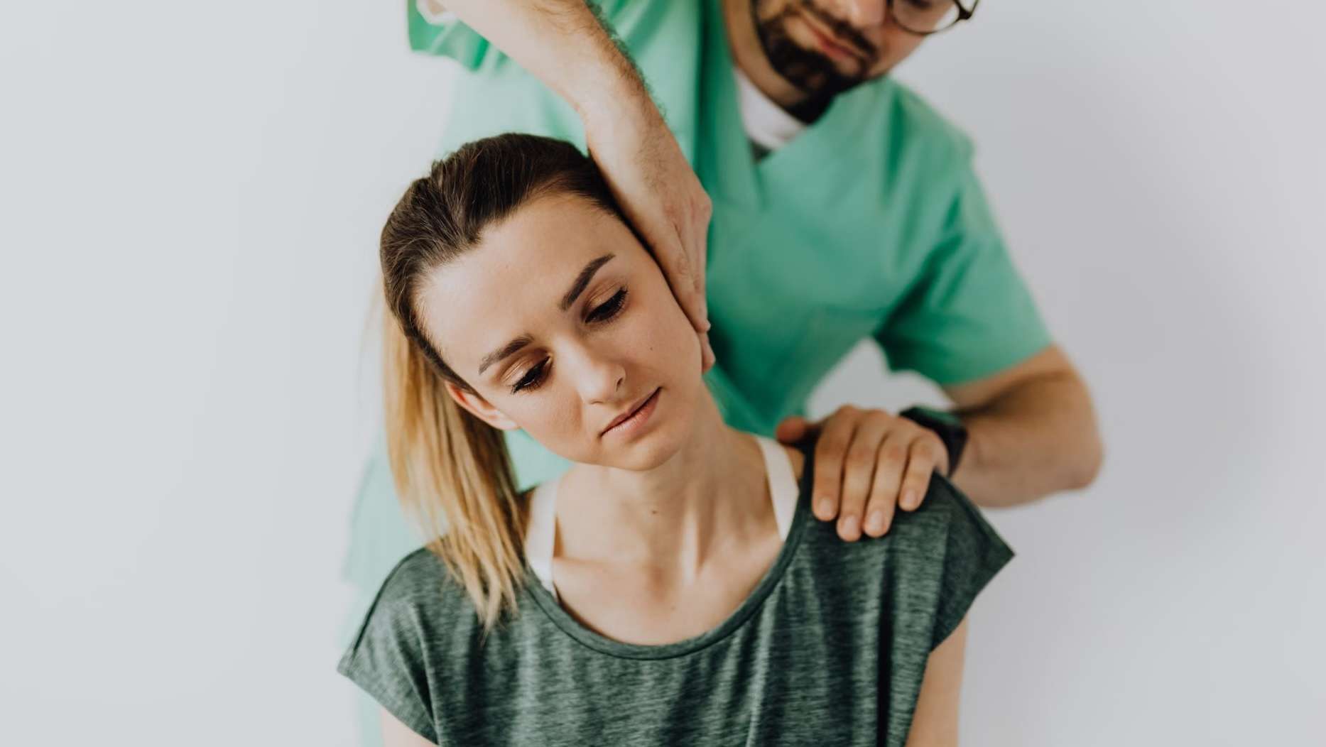 Chiropractor performing a hands-on cervical spine treatment on a patient to ease chronic neck pain and stiffness