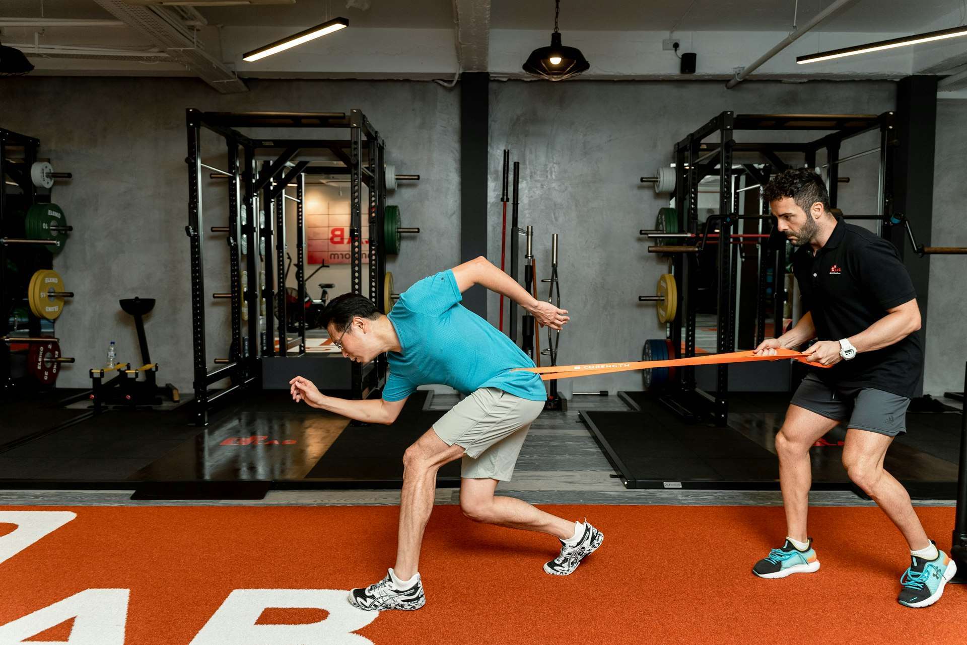 Athlete working against a resistance band, the graded loading that rebuilds strength during quadriceps strain recovery.