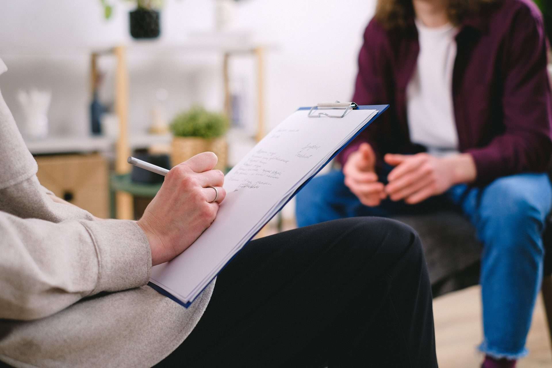 Clinician talking with a patient about neck pain symptoms and goals before treatment